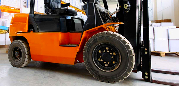 Orange forklift in an industrial setting